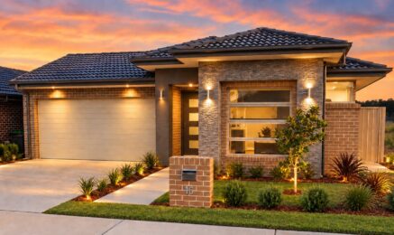 Single storey home in Jordan Springs with a tiled hip roof, stone feature entry, face brick walls and a double garage